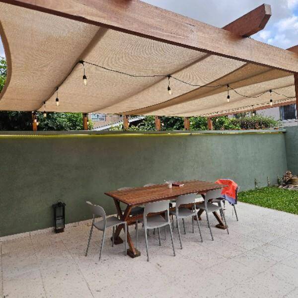 Coolaroo shade sail above a patio and garden